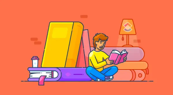 Un joven lee un libro rosa sentado entre grandes libros, buscando inspiración para sus propios libros para empezar a leer adultos.
